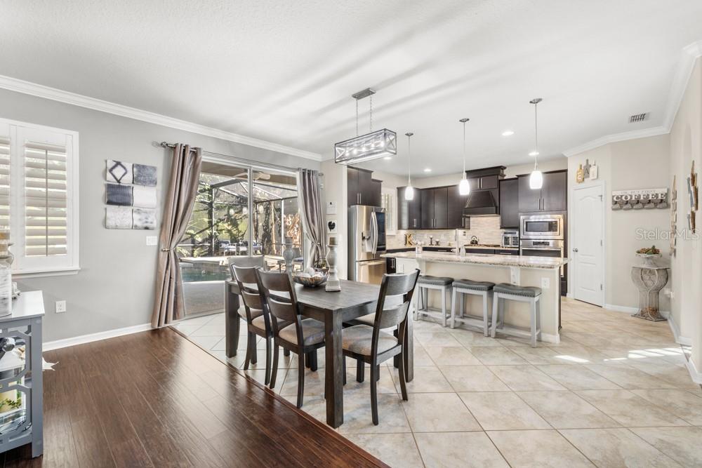 706 Fringe Tree Court Deland, FL 32724 - Photo 9 of 70 a view of a dining room with furniture and wooden floor