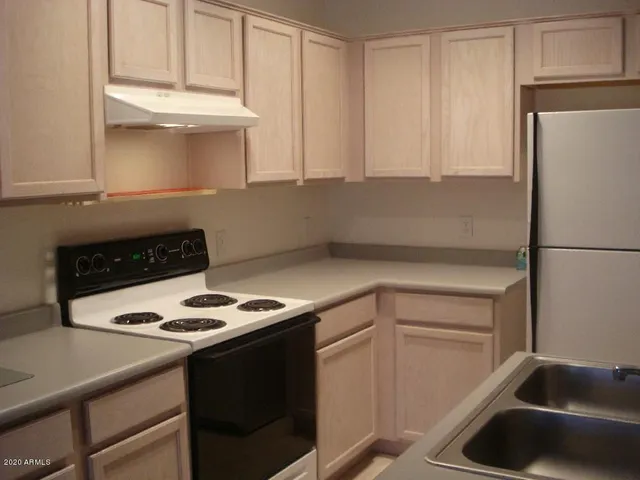 a kitchen with a sink cabinets and appliances