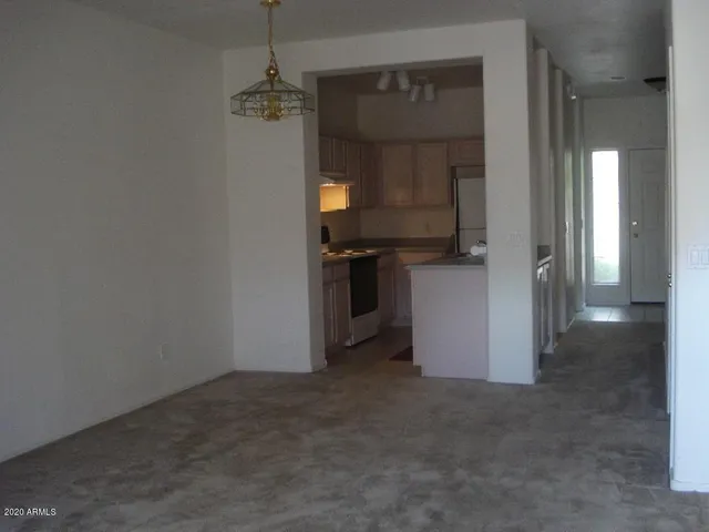 a kitchen with a refrigerator and a stove