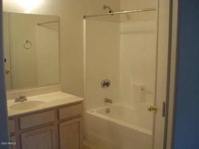 a bathroom with a shower and a sink