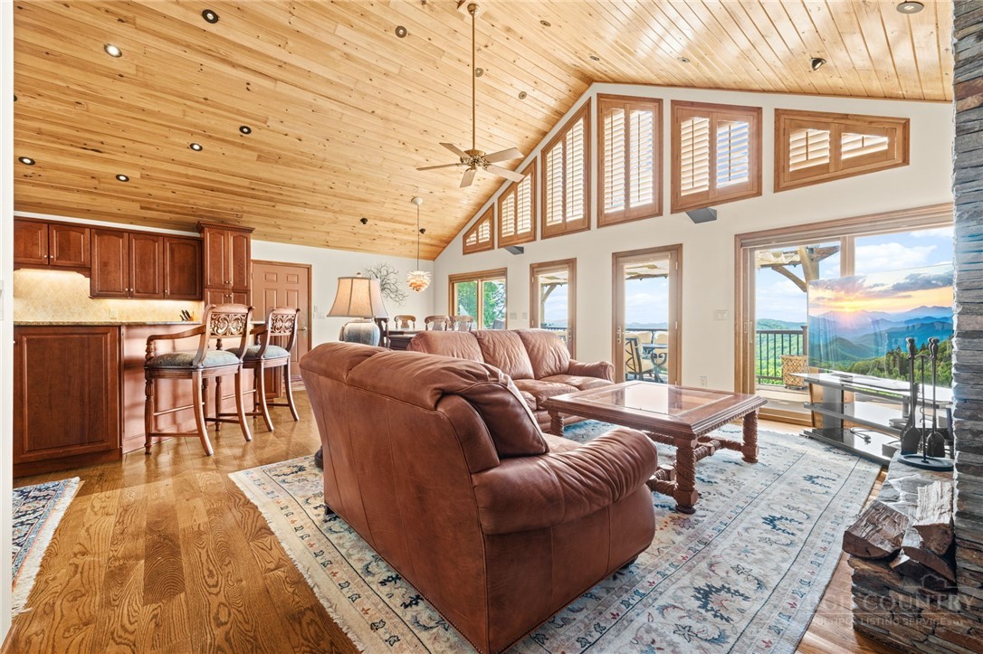 331 Alpine Road Blowing Rock, NC 28605 - Photo 14 of 50 a living room with furniture a wooden floor and next to a large window