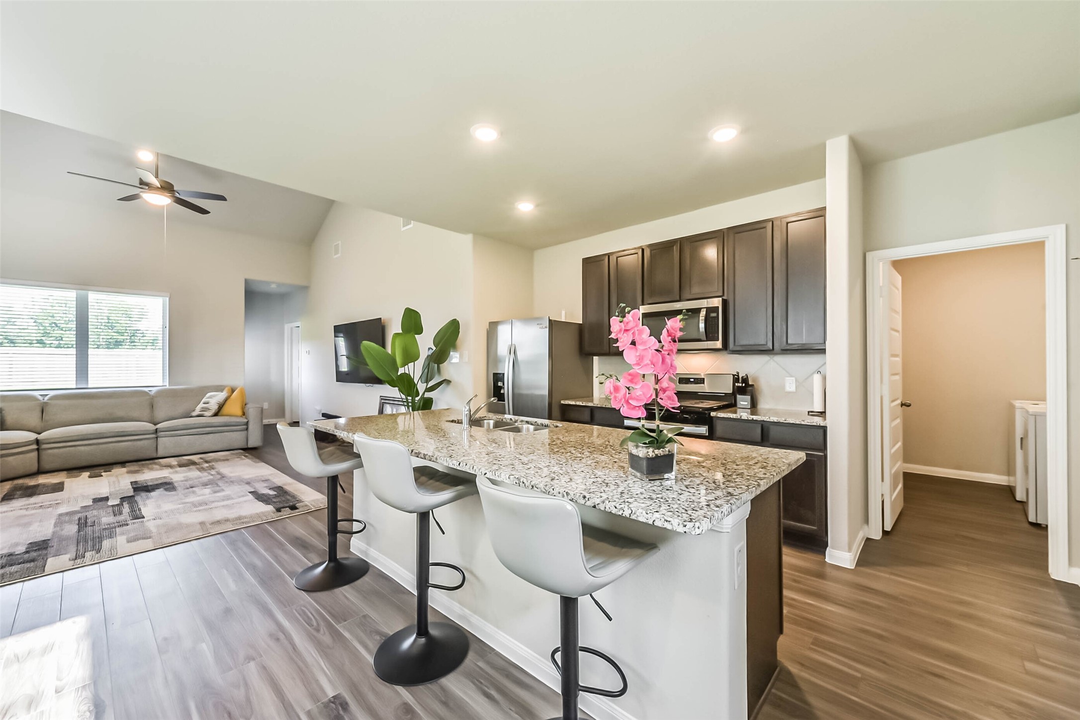 4907 Luke Matthew Drive Rosharon, TX 77583 - Photo 11 of 42 a view of a kitchen and dining area with wooden floor