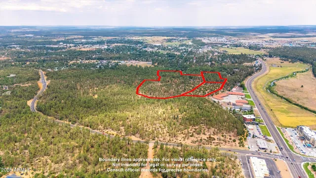 an aerial view of residential houses with outdoor space and swimming pool