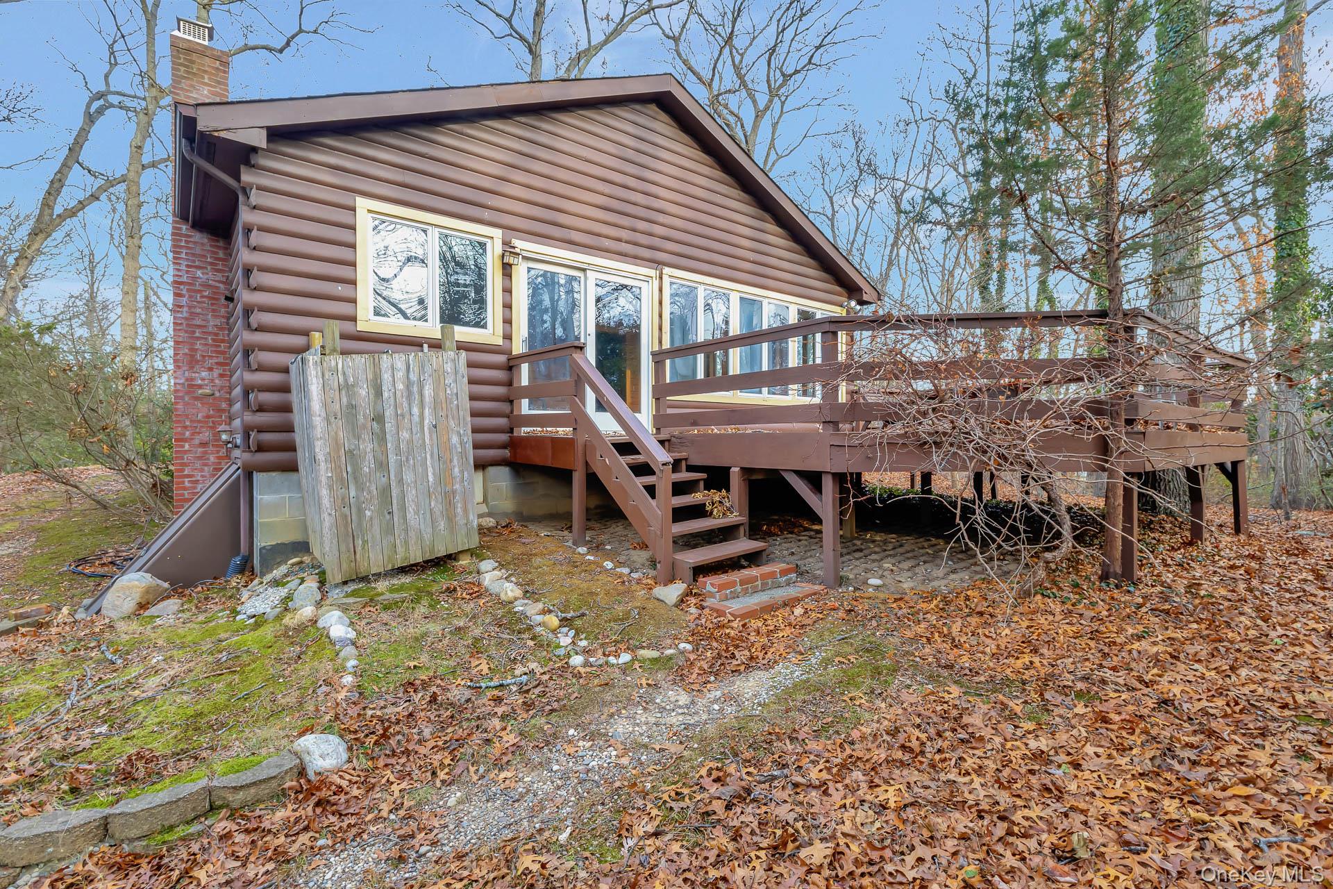 62 Birch Hill Road Mount Sinai, NY 11766 - Photo 18 of 36 a backyard of a house with table and chairs