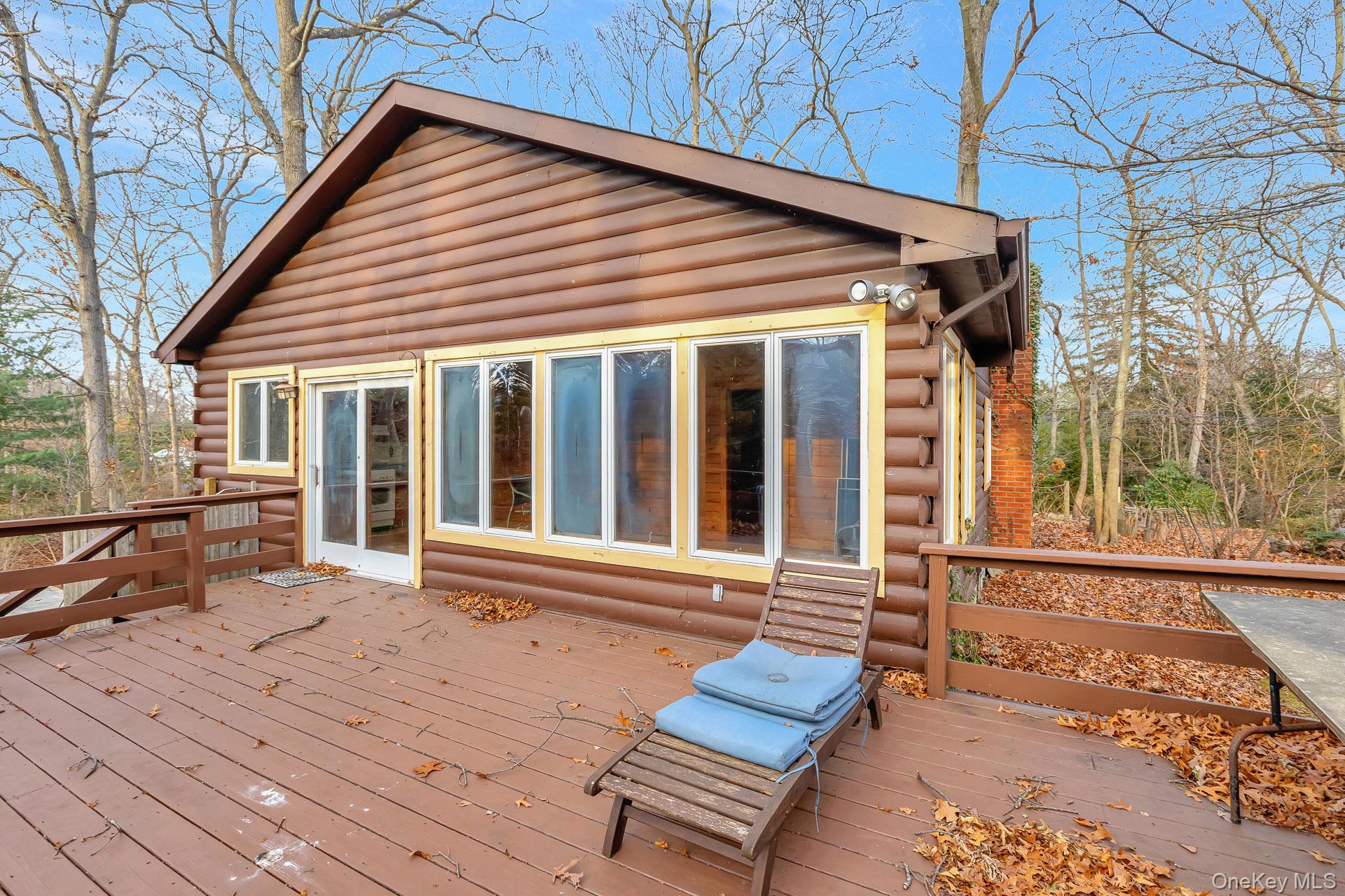 62 Birch Hill Road Mount Sinai, NY 11766 - Photo 21 of 36 front view of a house with a bench