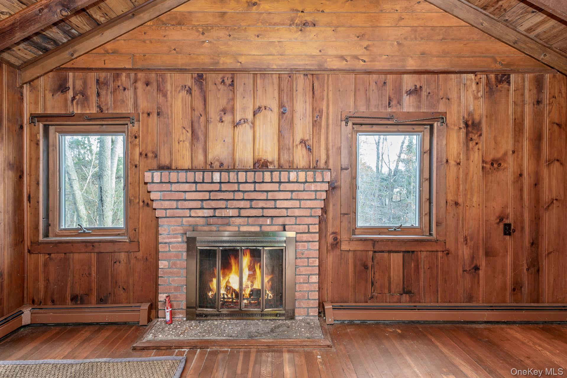 62 Birch Hill Road Mount Sinai, NY 11766 - Photo 4 of 36 a view of a fireplace with wooden floor