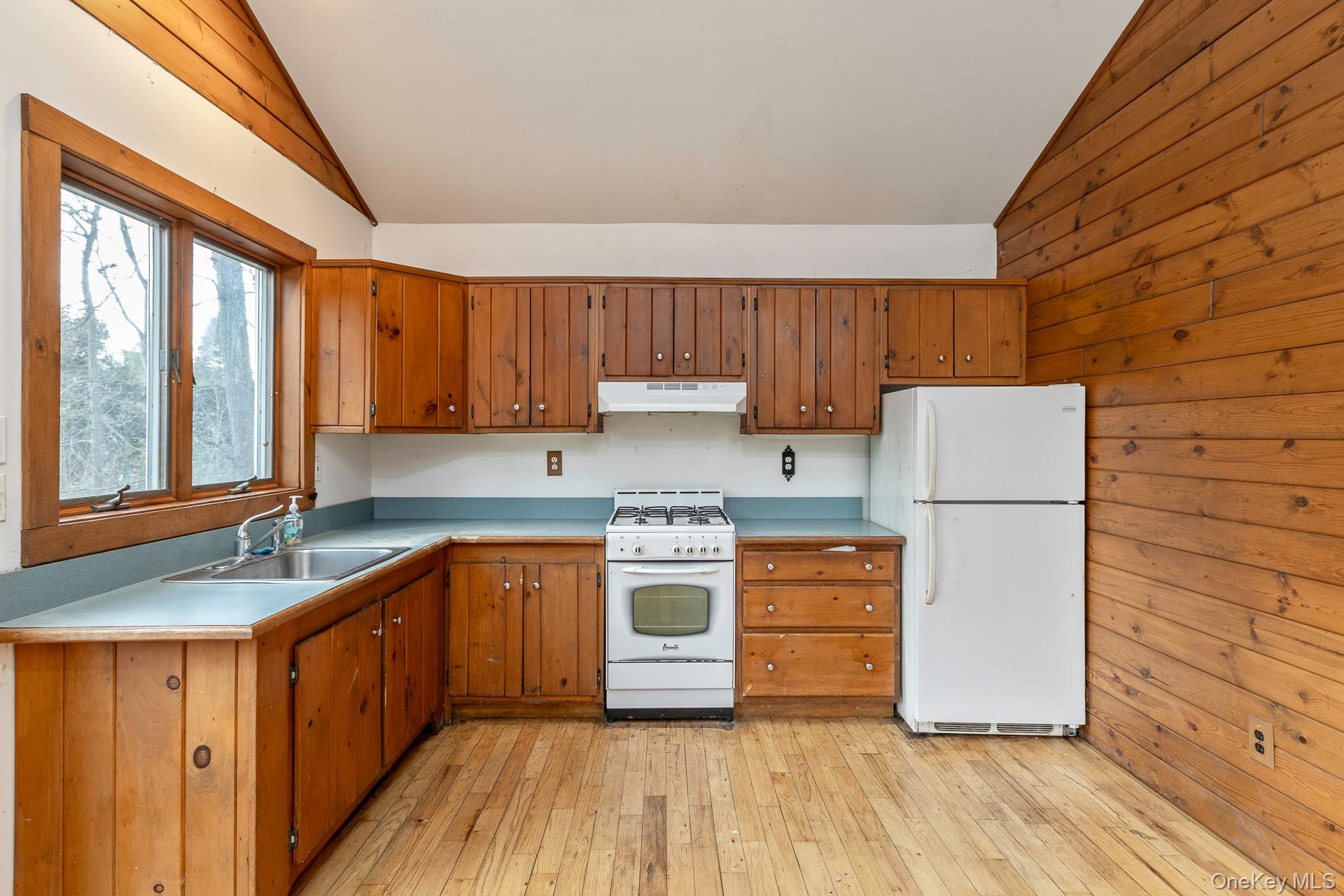 62 Birch Hill Road Mount Sinai, NY 11766 - Photo 9 of 36 a kitchen with wooden cabinets and white appliances
