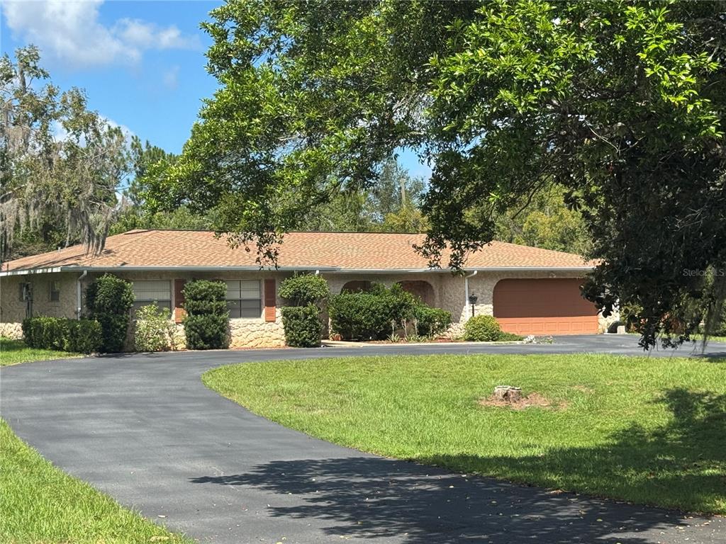 3621 East Country Side Drive Inverness, FL 34452 - Photo 1 of 1 a front view of a house with a yard and a garage