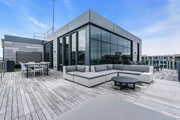a building outdoor space with patio furniture and potted plants
