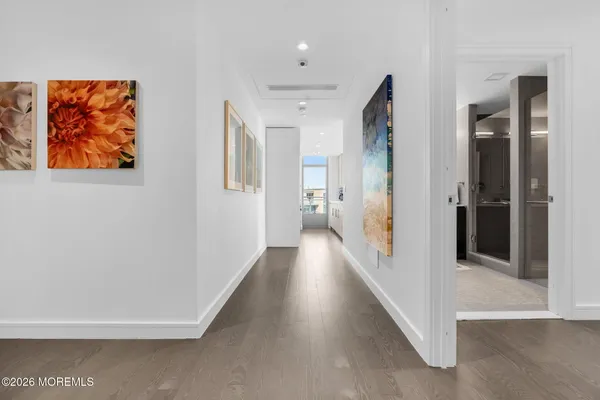 a view of a hallway with wooden floor and glass doors