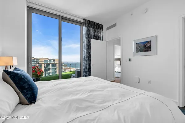 a bedroom with a large bed and a large window