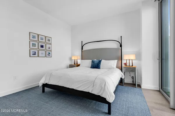 a bedroom with a bed and a night stand