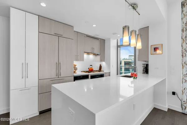 a kitchen with a sink and white cabinets
