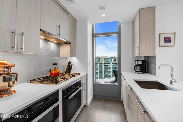 a kitchen with a stove a sink and a refrigerator