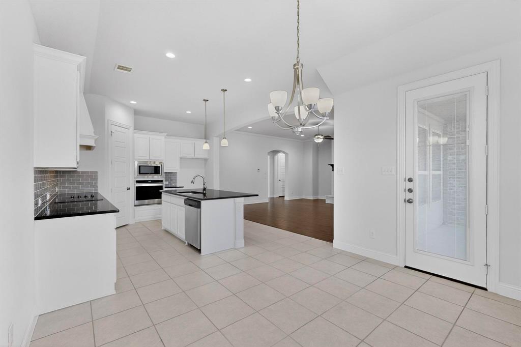 805 Rustic Trail Midlothian, TX 76065 - Photo 11 of 40 a large kitchen with kitchen island granite countertop a large counter top and stainless steel appliances