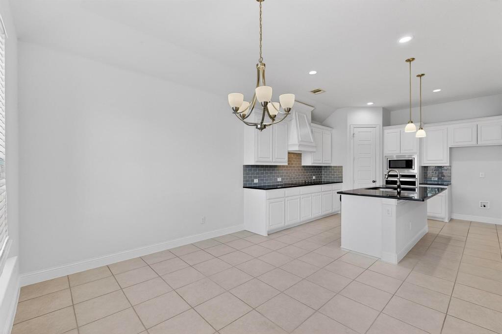 805 Rustic Trail Midlothian, TX 76065 - Photo 13 of 40 a kitchen with a white cabinets and white appliances
