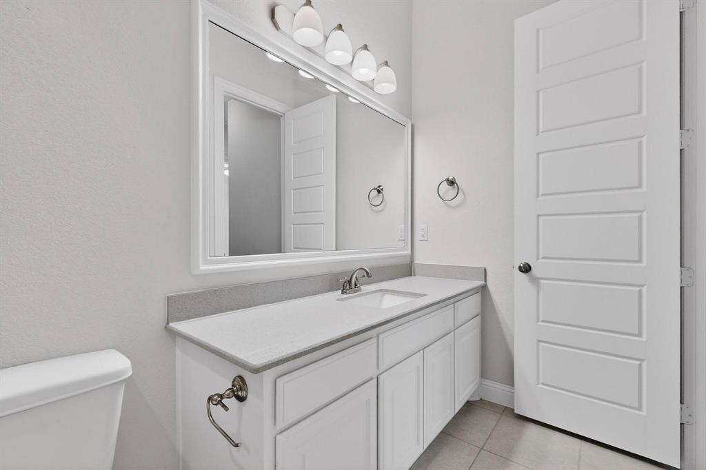 805 Rustic Trail Midlothian, TX 76065 - Photo 16 of 40 a bathroom with a sink and a mirror