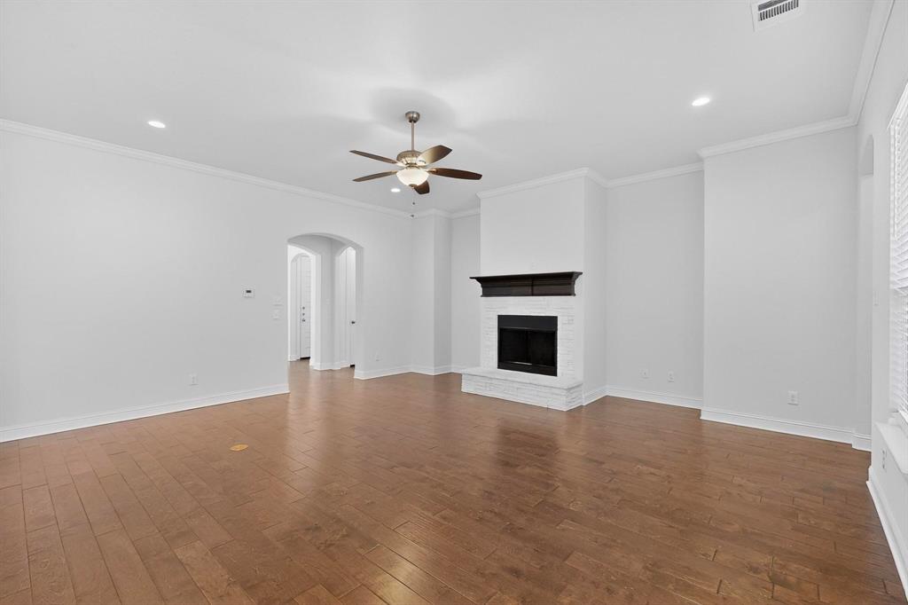 805 Rustic Trail Midlothian, TX 76065 - Photo 5 of 40 an empty room with chandelier fan and fireplace