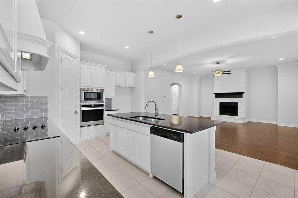 805 Rustic Trail Midlothian, TX 76065 - Photo 8 of 40 a kitchen with stainless steel appliances kitchen island granite countertop a sink and a stove