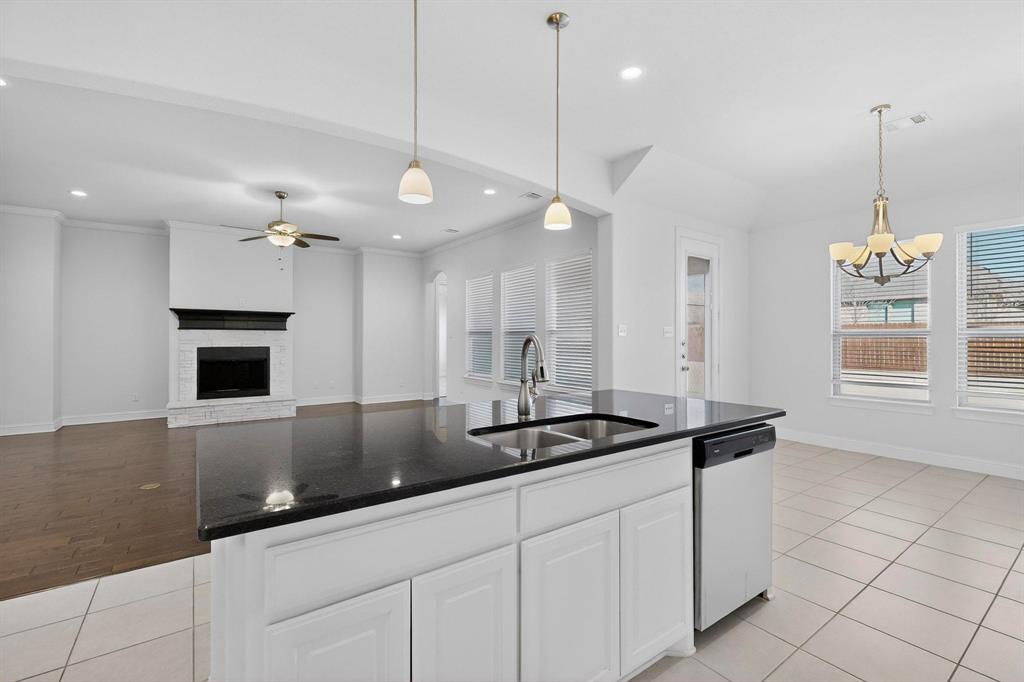 805 Rustic Trail Midlothian, TX 76065 - Photo 9 of 40 a kitchen with a sink and chandelier