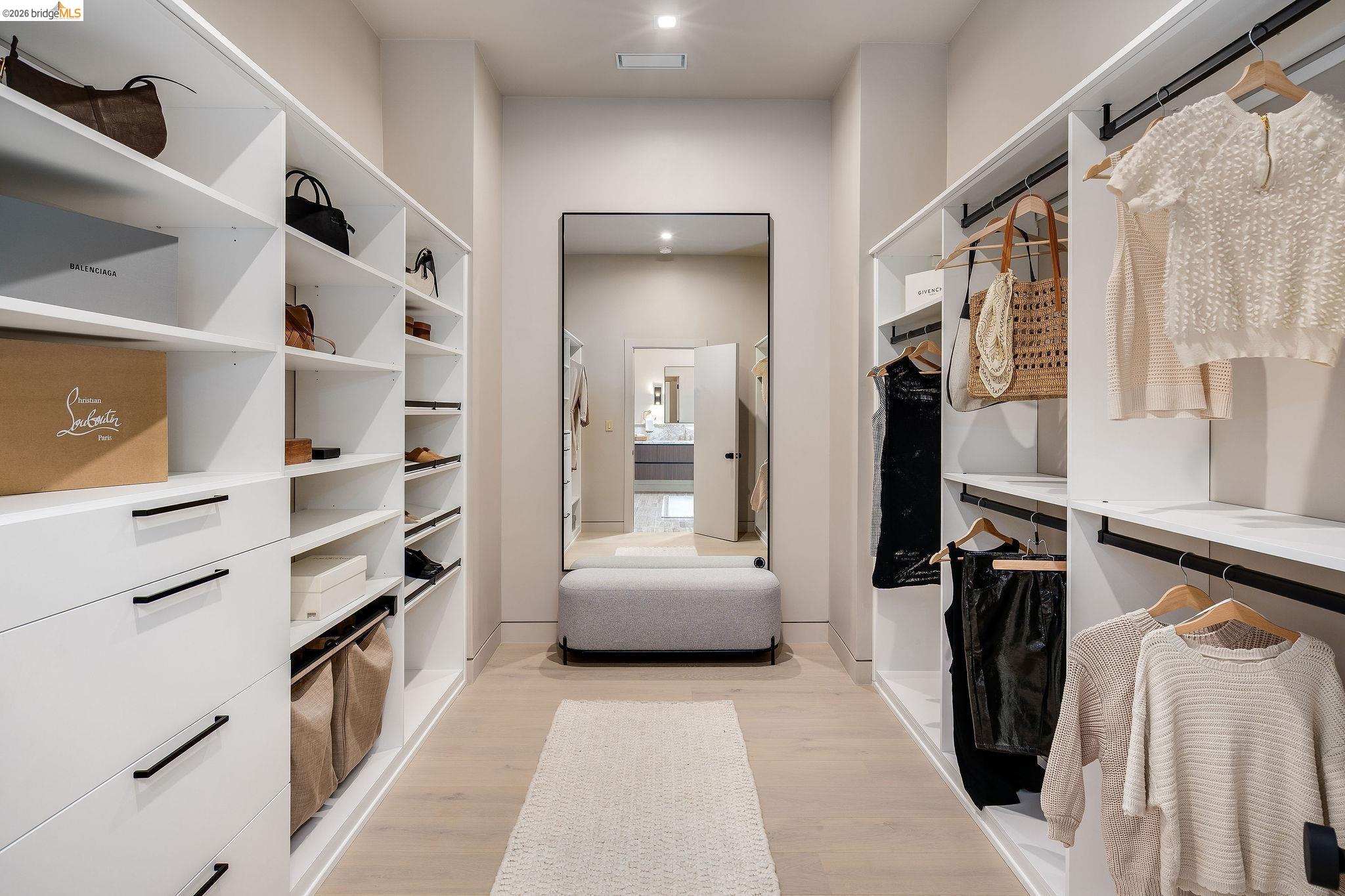 5645 Bacon Road Oakland, CA 94619 - Photo 72 of 94 Spacious walk-in closet featuring custom white cabinetry with ample shelving and drawers, built-in hanging rods, wood-finish flooring, and recessed lighting