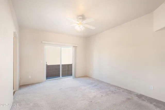 an empty room with closet and windows