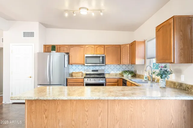 a kitchen with granite countertop a sink and a counter top space