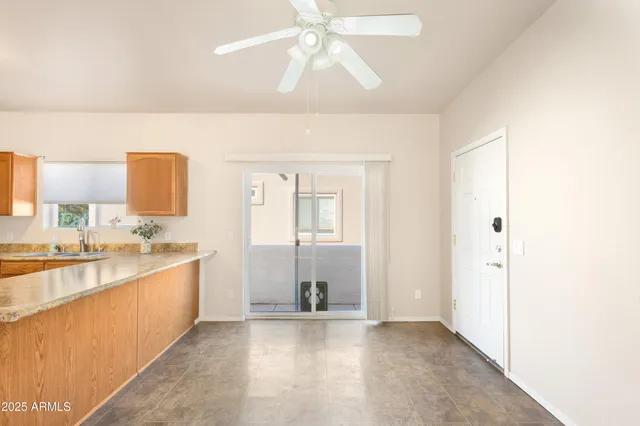 a large white kitchen with a sink and dishwasher a stove top oven with wooden floor