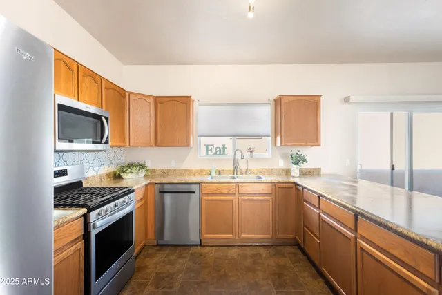 a kitchen with a sink stove top oven and cabinets