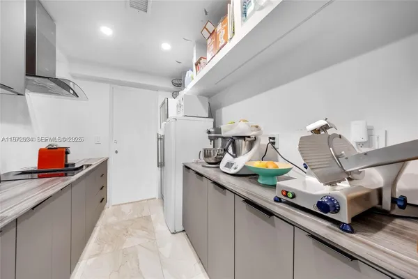 a kitchen with kitchen island a sink stainless steel appliances and cabinets
