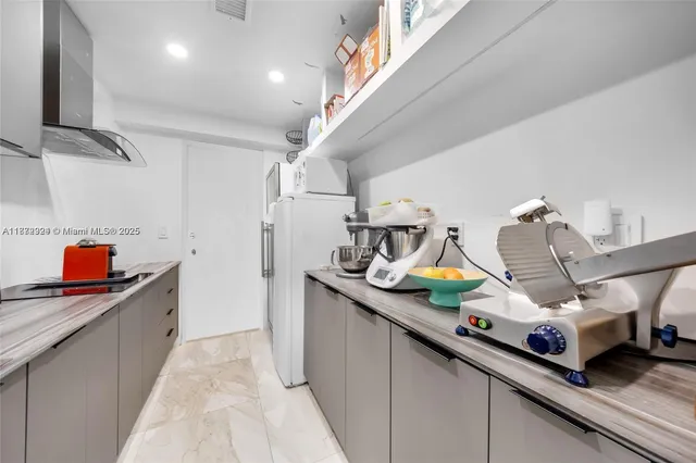a kitchen with kitchen island a sink stainless steel appliances and cabinets