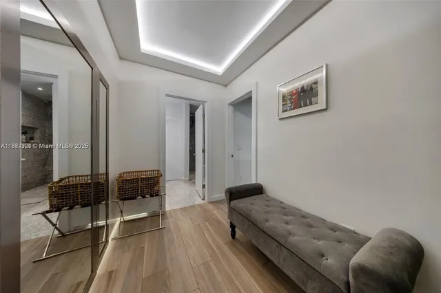 a bed sitting in a bedroom and chandelier