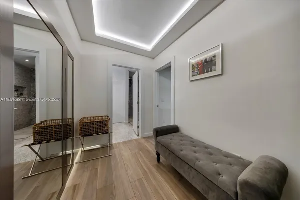 a bed sitting in a bedroom and chandelier