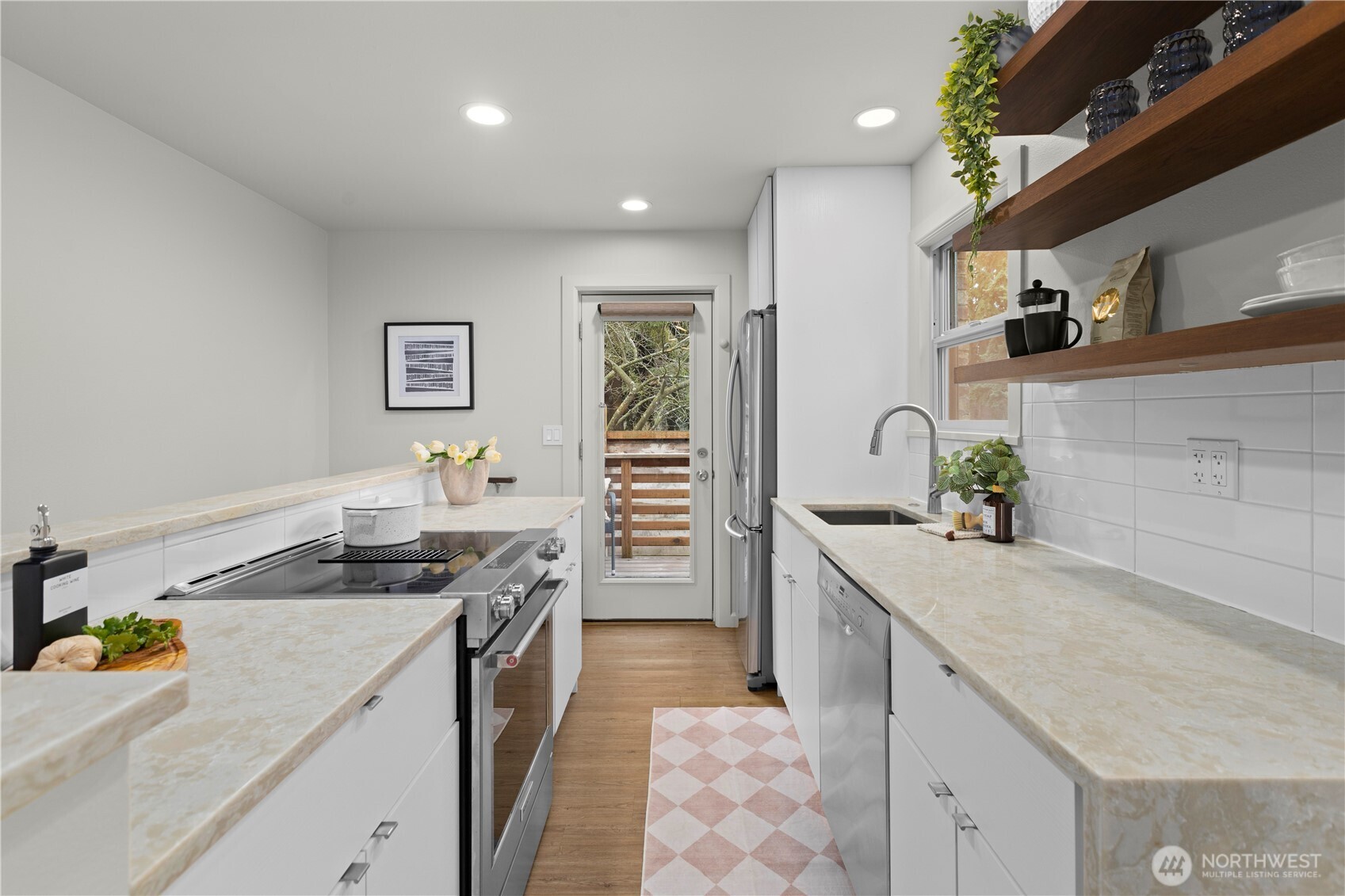 3911 Southwest Forest Street Seattle, WA 98116 - Photo 13 of 40 a kitchen with a sink stove and refrigerator