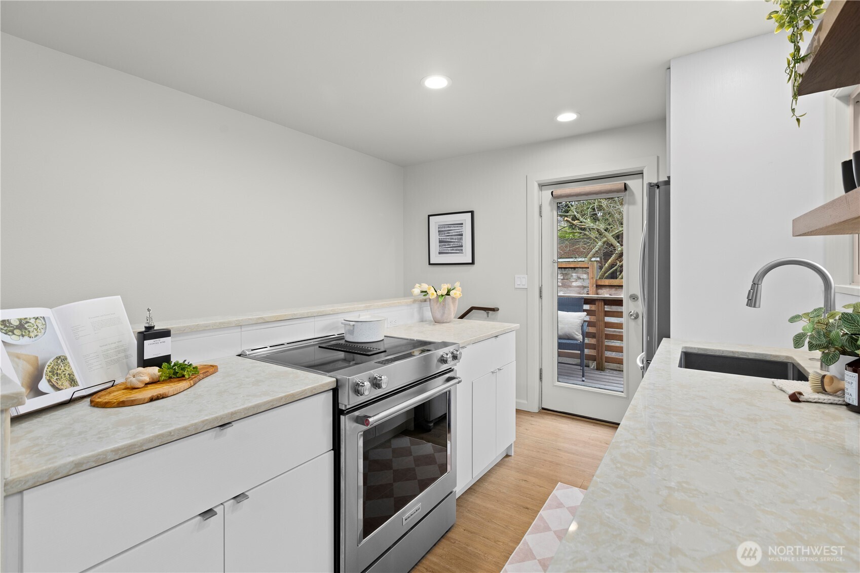 3911 Southwest Forest Street Seattle, WA 98116 - Photo 14 of 40 a kitchen with stainless steel appliances granite countertop a stove a sink and a refrigerator