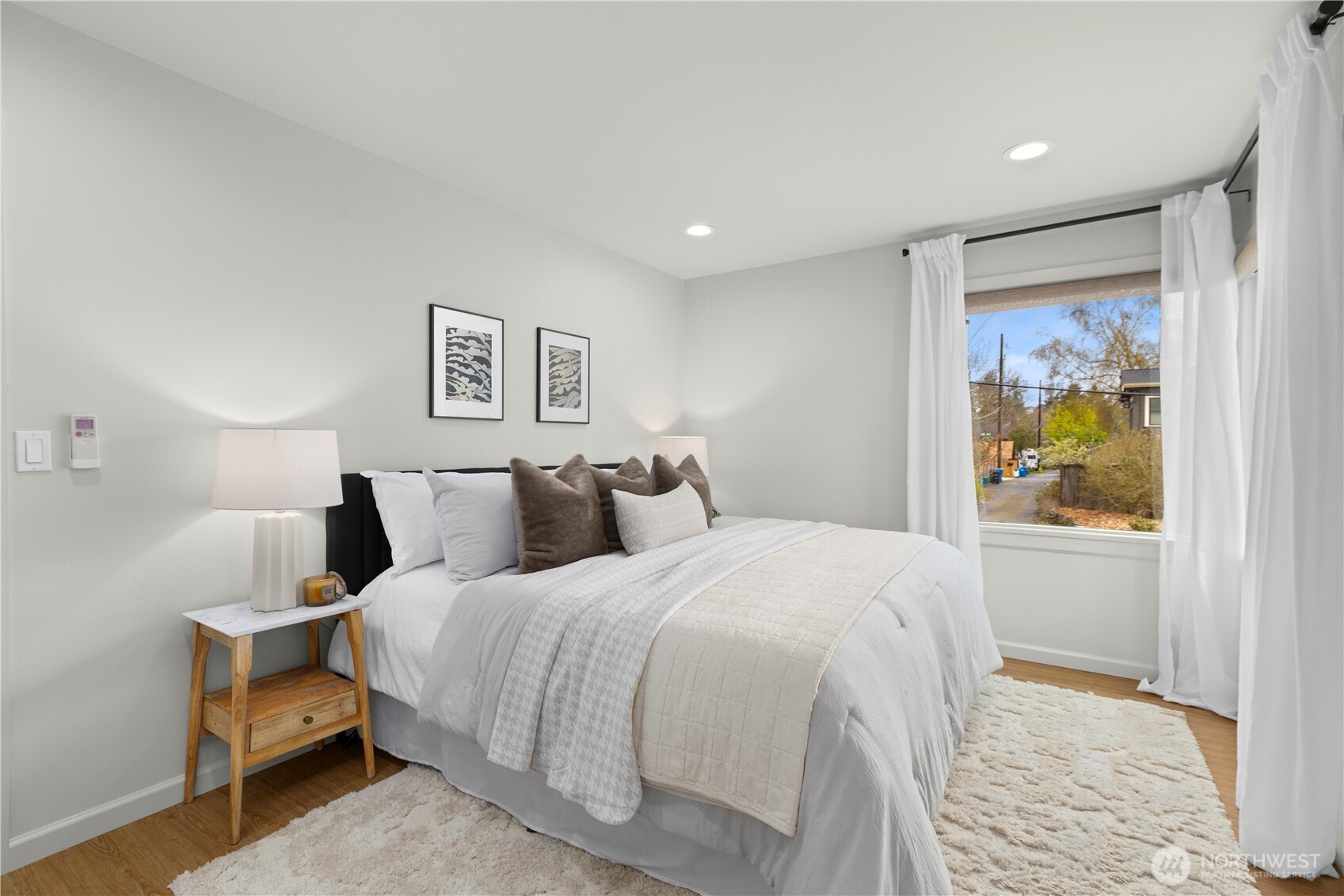 3911 Southwest Forest Street Seattle, WA 98116 - Photo 16 of 40 a bedroom with a bed and painting on the wall