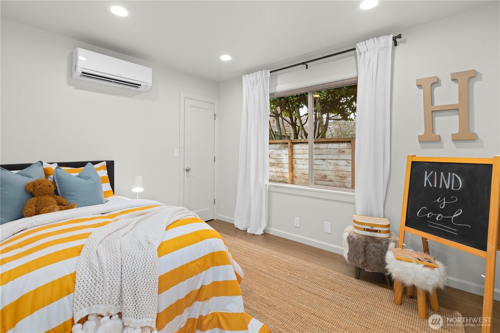 3911 Southwest Forest Street Seattle, WA 98116 - Photo 18 of 40 a bedroom with a bed and wooden floor