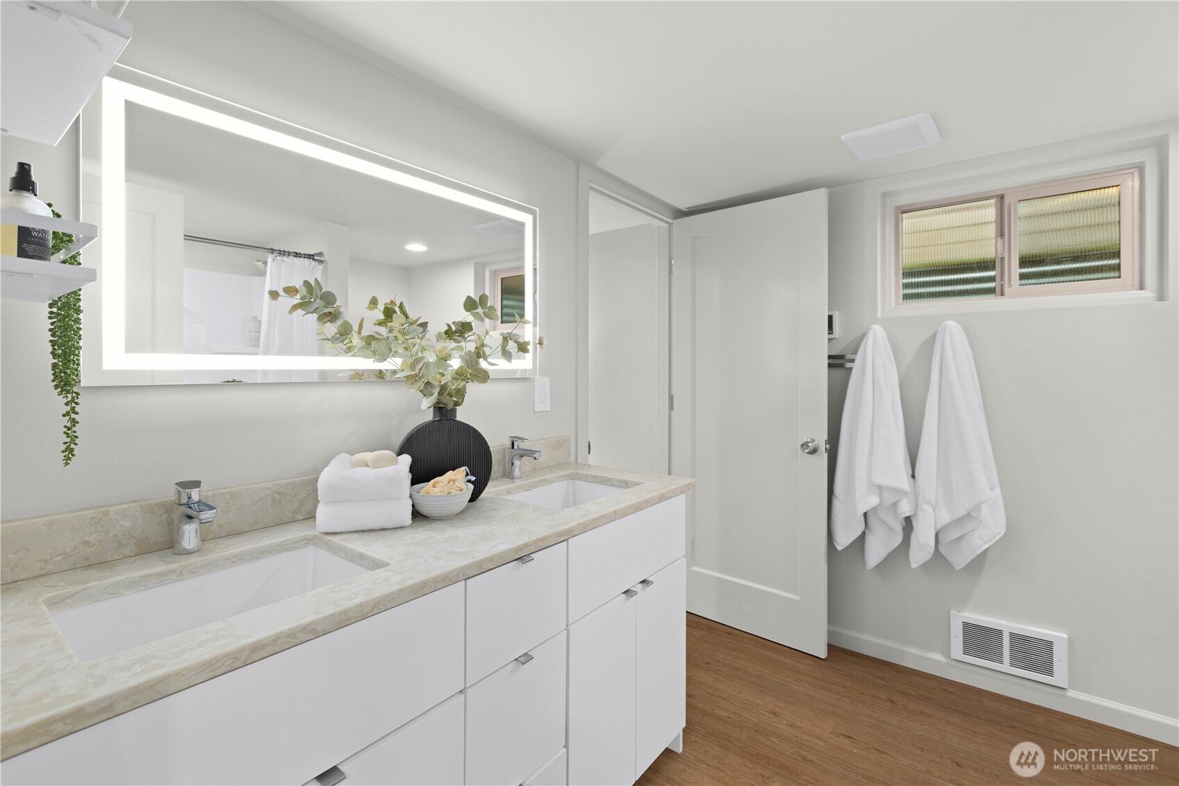 3911 Southwest Forest Street Seattle, WA 98116 - Photo 24 of 40 a bathroom with a double vanity sink and mirror