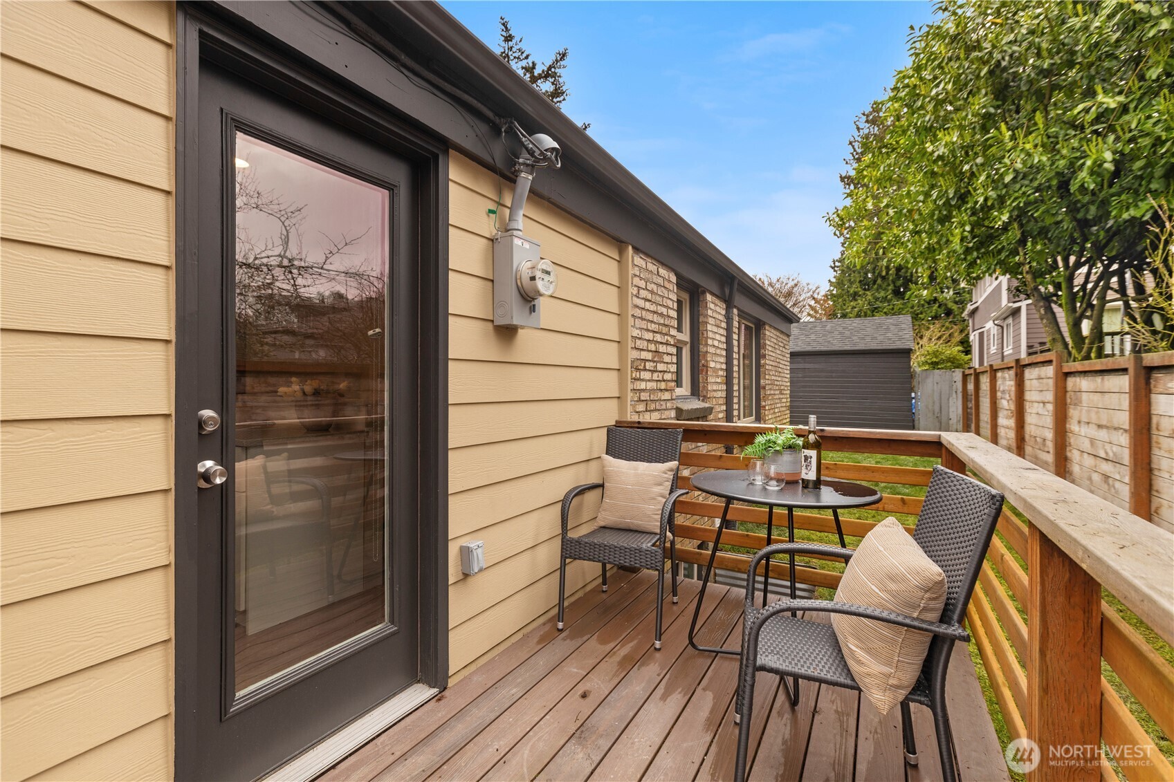 3911 Southwest Forest Street Seattle, WA 98116 - Photo 31 of 40 a view of deck with table and chairs and wooden floor