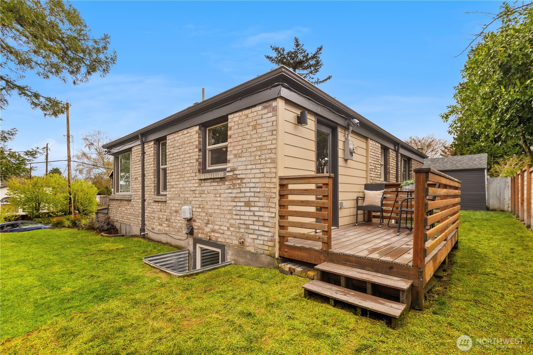3911 Southwest Forest Street Seattle, WA 98116 - Photo 33 of 40 a backyard of a house with barbeque oven and trees