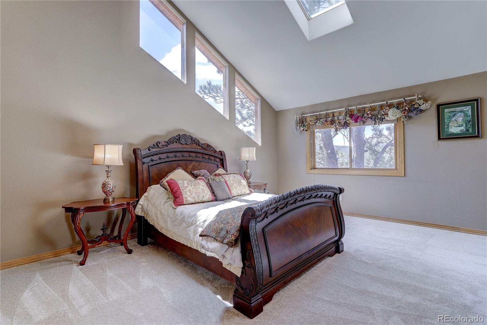 109 Royal Ridge Drive Bailey, CO 80421 - Photo 21 of 39 a bedroom with a bed and chair