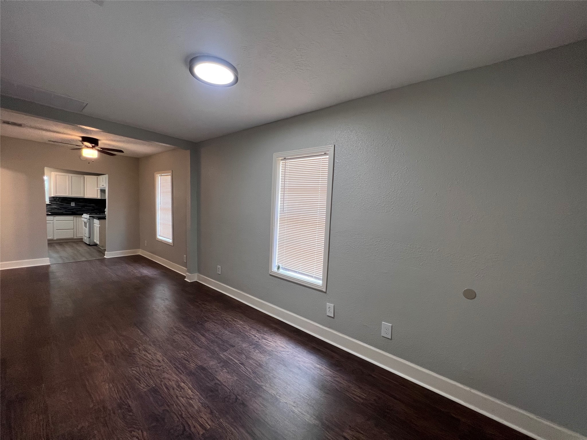2412 Stuart Street Houston, TX 77004 - Photo 4 of 32 an empty room with wooden floor and windows