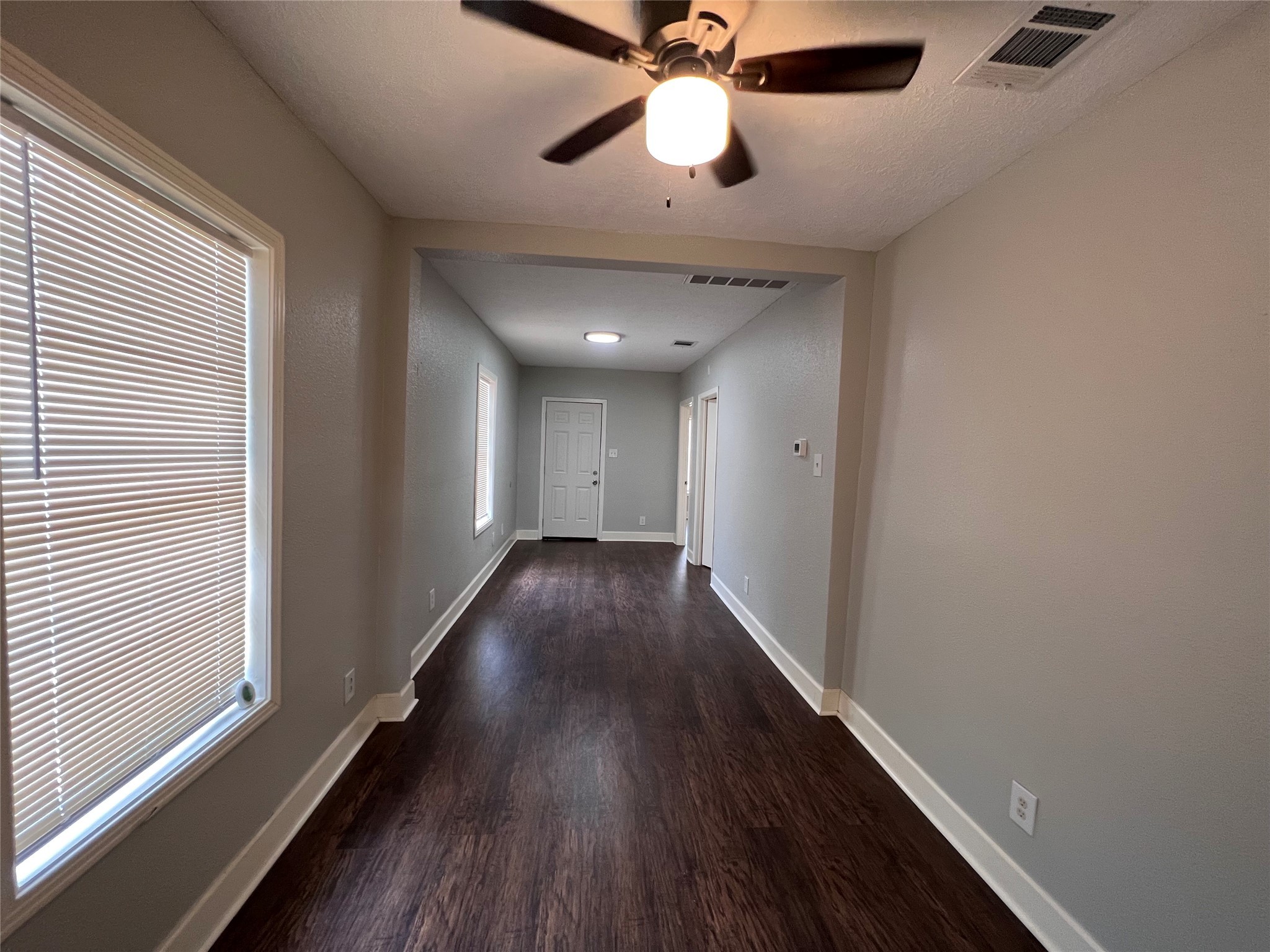2412 Stuart Street Houston, TX 77004 - Photo 6 of 32 a view of a hallway with wooden floor