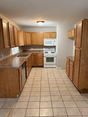 a kitchen with stainless steel appliances a refrigerator sink and cabinets