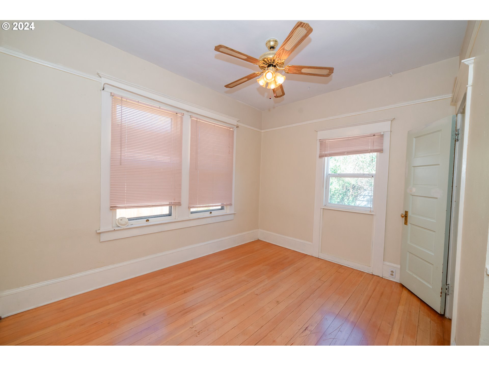 1306 Northeast Birch Street Camas, WA 98607 - Photo 14 of 23 a view of an empty room with wooden floor and a window