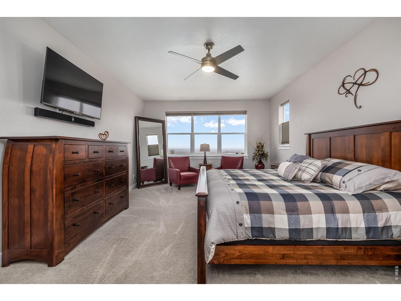 3789 Bridle Ridge Circle Severance, CO 80524 - Photo 21 of 44 a bedroom with a bed and a flat screen tv