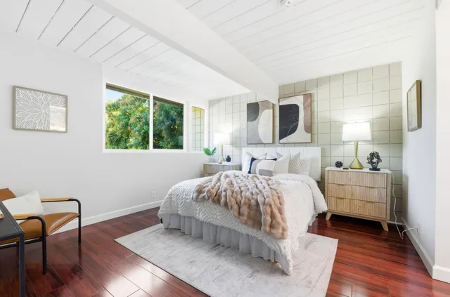 a bedroom with bed and a chair