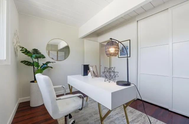 a bedroom with a bed and a chair