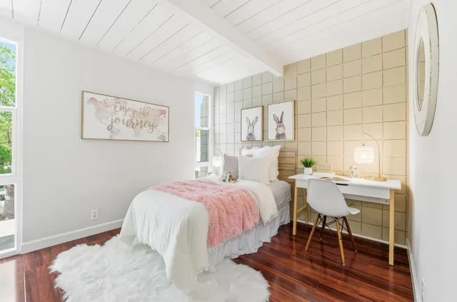 a bedroom with a bed and a painting on the wall