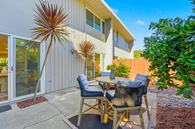 a view of a porch with furniture and floor to ceiling window
